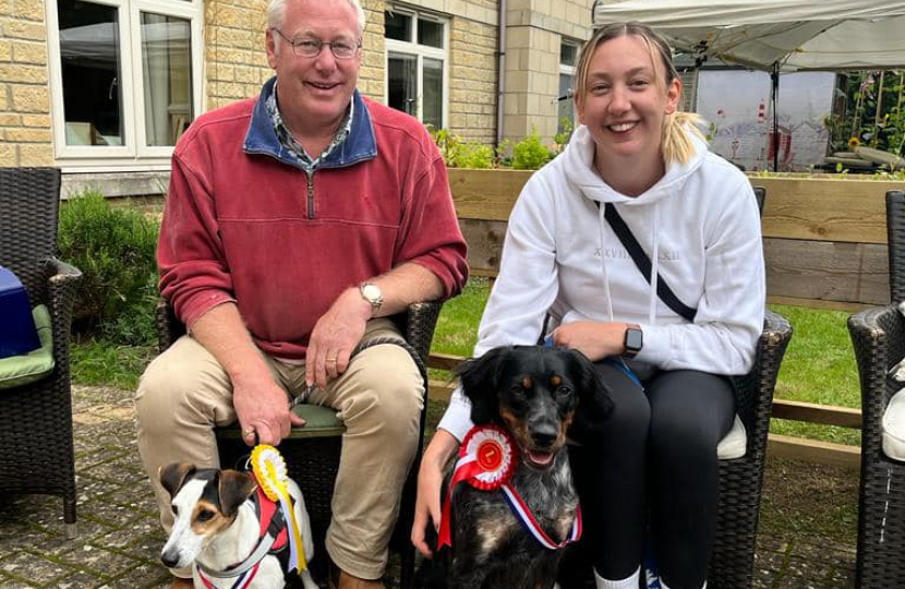 Nic and his daughter alongside their dogs.