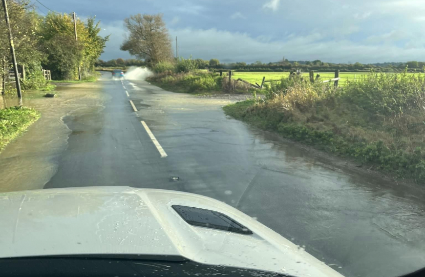 Image of a flooded road taken from a parked car.