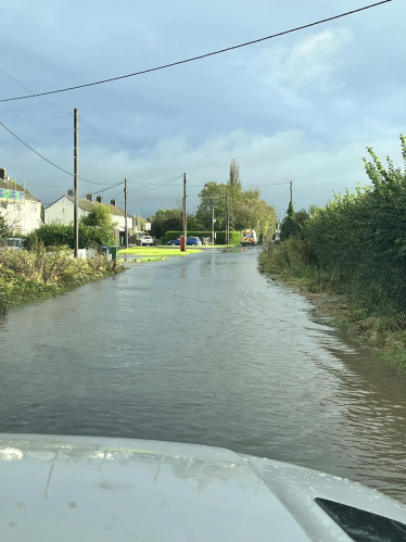 Image of a flooded road taken from a parked car.